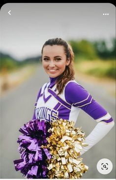 a girl in purple and gold cheerleader uniform holding a pom pom while smiling at the camera