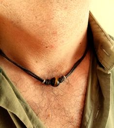 Surfeur style choker necklace made with natural tiger eye stone bead and brown wax cotton cord, stainless steel lobster clasp closure. All metal components are stainless steel. Simple every day cord necklace for men, brown stone choker for him.  Mens minimalist rope necklace a perfect gift for him. Tiger eye bead cord necklace, choker necklace for him, boyfriend gift. Tiger eye stone beads: 12 mm Tigers Eye is good for growing your confidence and strength and it is known as the stone of courage. It is a root and sacral chakra stone which means it helps you to get grounded, build a safe and strong foundation, and find your motivation once more. It's also good at warding off negative energy.  /Gift wrapping and packaging/ :   All items ordered will be placed in a gift bag and shipped in a bu Beach Jewelry For Men, Beaded Necklace Men’s, Diy Necklace Men, Mens Beaded Necklace, Men’s Beaded Necklace, Men’s Necklaces, Men’s Jewelry, Mens Bracelet Diy, Mens Choker Necklace