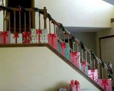 presents are wrapped in pink and green paper under the banister