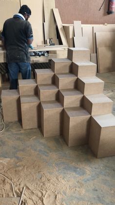 a man working on some kind of cardboard structure