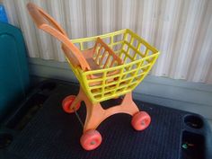 a toy shopping cart sitting on top of a mat