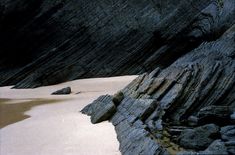 a black and white photo of some rocks in the water