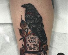 a black bird sitting on top of a tombstone with the words it can't rain all the time