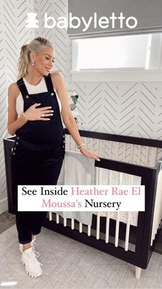 a woman standing next to a baby crib with the words see inside heather rae el moussa's nursery