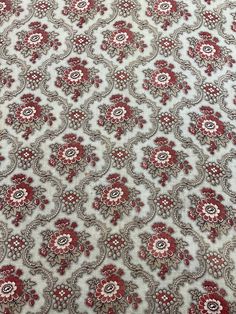 a red and white floral pattern on fabric