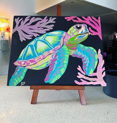 a painting of a sea turtle on an easel