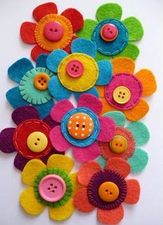 several colorful flowers with buttons on them