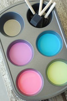 cupcake tins filled with different colored batter