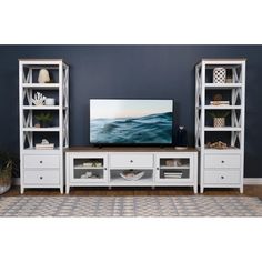 a white entertainment center with open shelving units