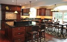 a large kitchen with wooden cabinets and an island in front of the stove top oven