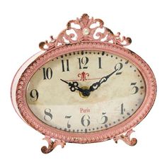 an ornate pink clock with roman numerals