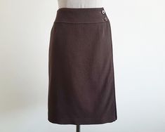 Vintage Brown Wrap Skirt - Label : COURREGES - Fabric : 99% wool 1% polyurethane  - Lining - Made in China - Very good vintage condition Measurements : Waist : 26" Hips : 40" Total length : 21"  Our products are vintage clothing that will be cleaned so you can be confident in the quality. We carefully inspect each garment to make sure that you get the most accurate and informed description possible. We do our best to state any imperfections in the listing. If a flaw accidentally escapes our inspection, please let me know as soon as possible and we will be happy to help remedy the situation. Please read the product description carefully before purchasing to ensure it meets your needs. If you have any questions, please feel free to contact us. Thank you very much for visiting our shop.