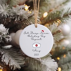 a christmas ornament hanging on a tree with the words eat sleep have holiday fun repeat