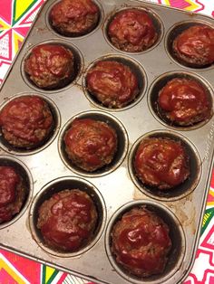 a muffin tin filled with lots of red food