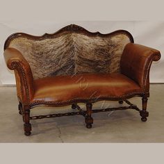 a brown leather chair with an animal print upholstered back