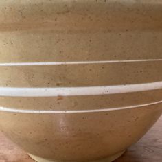 a brown bowl sitting on top of a wooden table