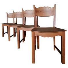 three wooden chairs sitting next to each other