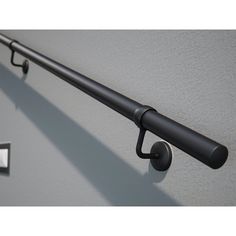 an image of a metal bar with hooks on the wall and two knobs attached to it