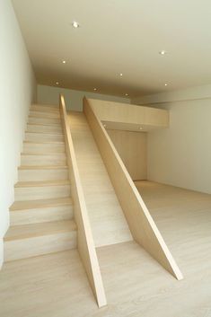 an empty room with stairs leading up to the second floor