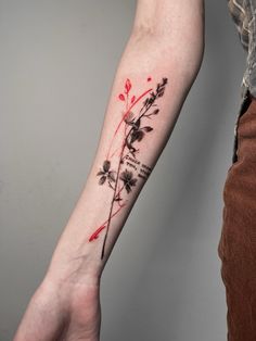 a person with a flower tattoo on their arm