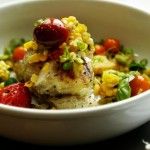 a white bowl filled with food on top of a table