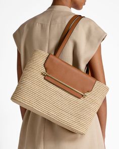 Our holiday favourite Strathberry Basket - an ethically-crafted statement piece designed for your summer wardrobe is now available in a larger size. Reminiscent of sunny days spent in leisure, this woven raffia bag was handcrafted by women in Morocco, providing them with an additional income and a flexible working schedule. Featuring our signature music bar, tan leather handles and a leather interior compartment with zip, keep all your summer holiday essentials handy and help support local artisans.Please note - As this basket is handcrafted, sizes may vary slightly from those shown, making every purchase unique. Summer Holiday Essentials, Music Bar, Additional Income, Holiday Essentials, Flexible Working, Woven Raffia, Raffia Bag, Basket Bag, Natural Tan