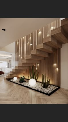 an indoor area with plants and rocks under the stair railing, along with lights on the wall