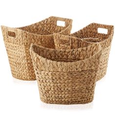 four woven baskets with handles on white background