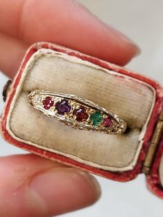 A beautifully detailed "REGARD" ring. A regard ring is a Victorian style romantic ring with five different types of gemstone. The term "Regard" is an acronym, encompassing the different types of stone on the ring. These are: Ruby, Emerald, Garnet, Amethyst, Ruby, and Diamond. This is a very special ring which would make a very thoughtful and romantic gift. Size UK O US 7.25 Eu 55.5 - if sizing is required please get in touch. Weight: 1.83 g Width of the ring front measure 5 mm Fully hallmarked for solid 9 ct gold. REM makers mark. Birmingham assay mark. One side of the regard setting is ever so slightly misshapen. This isn't visible when worn but I have tried to show it in thr final image. This is reflected in the price. Please be aware that we used a macro lens to photograph our item clos Regard Ring, Vintage Ruby Ring, Engagements Rings, Romantic Rings, Pretty Accessories, Ring Inspo, Special Ring, Ruby Emerald, Pretty Box