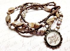 a close up of a bracelet with beads and charms on it's sides that says made for an angel