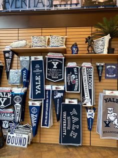 many items are hanging on the wall in front of a display case at a sporting store