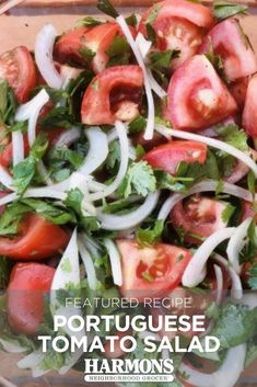 a salad with tomatoes, onions and lettuce on it in a glass bowl