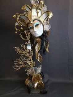 a mask with gold and black decorations on it