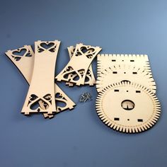 several pieces of wood cut out to look like gears and wheels on a blue surface