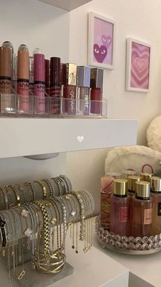 the shelves are filled with many different types of cosmetics and bracelets on display in front of them