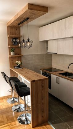 a kitchen with wooden counter tops and stools