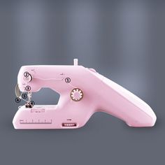 a pink sewing machine with instructions on how to use it