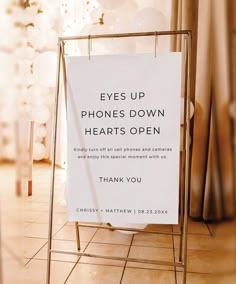 a sign that says eyes up phone's down hearts open thank you on it