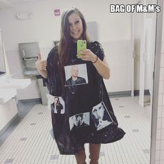 a woman in a bathroom taking a selfie with her cell phone and plastic bag