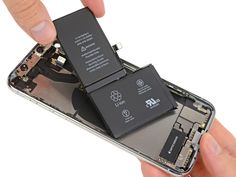 someone is removing the battery from their iphone