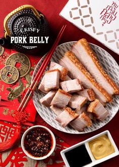 pork belly served on a plate with chopsticks and dipping sauce next to it