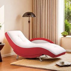 a red and white chaise lounge chair sitting on top of a rug in front of a window