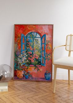 there is a painting on the wall next to a chair and vase with flowers in it