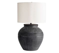 a large black vase with a white lamp on the base and a white linen shade