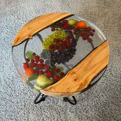 a glass table topped with fruit on top of a carpeted floor