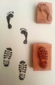 three rubber stamps with footprints on them