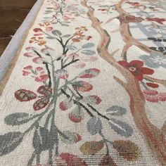 an area rug with flowers and leaves on it