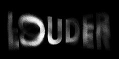 the word loud written in black and white with light coming from it's side