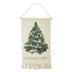 a white wall hanging with a christmas tree and joy peace noel written on the front