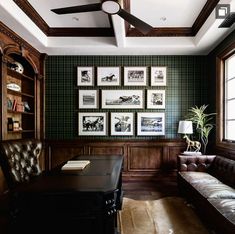 a living room filled with furniture and lots of framed pictures on the wall next to a window